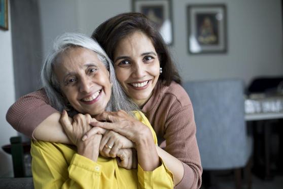 Mother hugging daughter