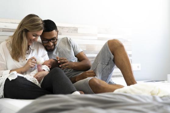 New parents feeding their infant